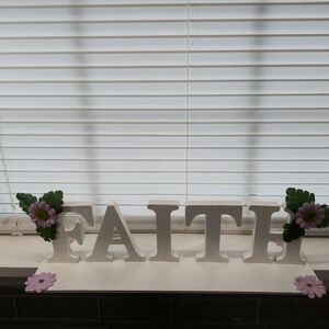 A faith sign with purple flower decor